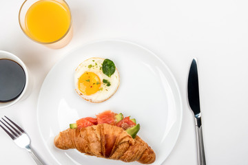 Plate with salmon, croissant and cottage cheese on a white background. 