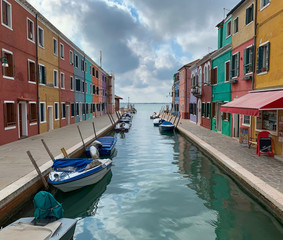 Fototapeta na wymiar Canal with small boats in Burano, Italy
