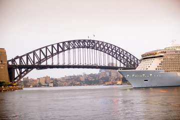 SYDNEY, AUSTRALIA - February 2, 2020: Sydney Harbour Bridge and Cruise Ship located in Sydney, NSW, Australia. Australia is a continent located in the south part of the earth.