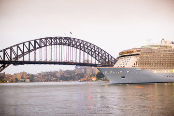 SYDNEY, AUSTRALIA - February 2, 2020: Sydney Harbour Bridge and Cruise Ship located in Sydney, NSW, Australia. Australia is a continent located in the south part of the earth.