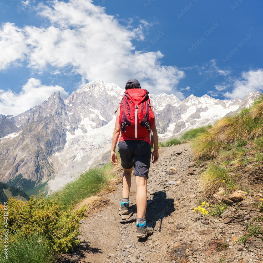 Wall mural a lone hiker on a hiking trail in the french alps near chamonix, france