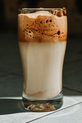 Closeup shot of Dalgona coffee in glass on a table