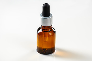 Skincare serum bottle on a light beige background close up