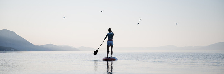 Woman paddling on sup board