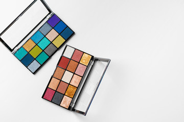 Make up colorful eyeshadow palettes isolated on white, top view