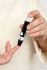 close-up female hands, woman makes test with lancet pen and glucometer, Medicine, glycemia,...