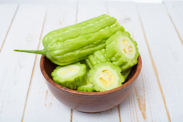Bitter melon on white wooden table