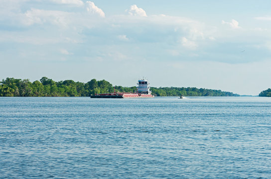 Barge And Boat Navigate Waters In Louisiana