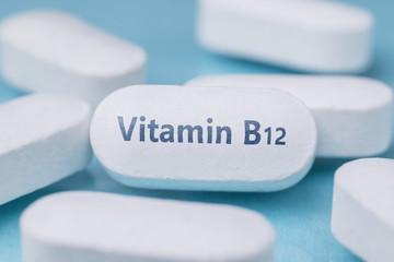 Obraz na płótnie Canvas White pills. On one of the pill is the inscription Vitamin B12.