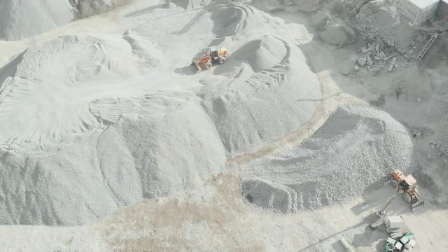Panorama aerial view shot open pit mine breakstone, dumpers, quarrying extractive industry stripping work. Big Mining Trucks. View from drone at opencast mining. Economic crisis. Unemployment.