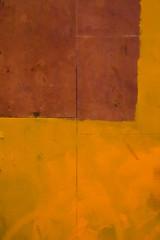abstract geometric minimalistic yellow wall background with brown element close up