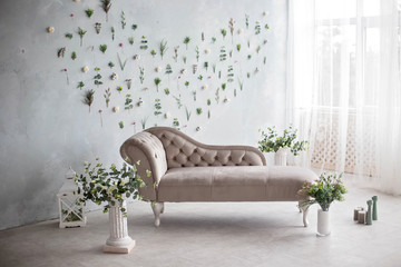 gray floral wall with gray sofa.