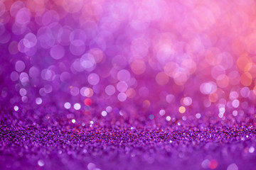 Decoration bokeh glitters background, abstract blurred backdrop with circles,modern design overlay with sparkling glimmers. Purple, pink and golden backdrop glittering sparks with glow effect