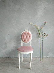 vintage medallion chair in a white wooden frame, tied with pink velvet against the background of a...