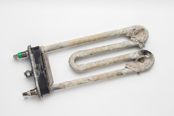 Dirty damaged electric heating element of the washing machine. Calcium and scale from hard water.