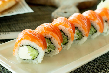 Philadelphia roll sushi with salmon, prawn, avocado, cream cheese. Sushi menu. Japanese food. delivery service.Sushi roll on a plate.Delicious rolls.traditional fresh healthy gourmet raw cuisine