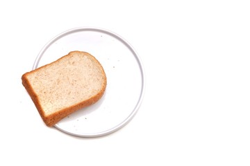A piece of sliced wholewheat bread on a white plate, white isolated background 