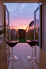 cozy evening wine with sunset through doors at home