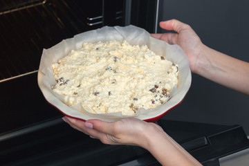 raw dough for curd casserole in a round ceramic form. Ready to put in the oven