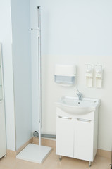 Sink and sanitizer in clinic. Medical equipment. Coronavirus pandemic