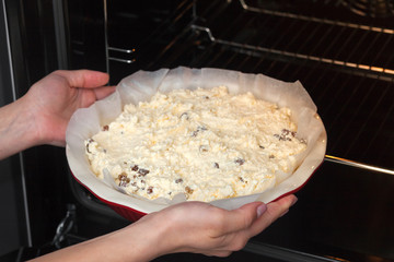 raw dough for curd casserole in a round ceramic form. Ready to put in the oven