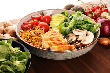 Healthy salad bowl with quinoa, tomatoes, chicken, avocado and mixed greens, lettuce. Food and health bowl