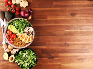 Healthy salad bowl with quinoa, tomatoes, chicken, avocado and mixed greens, lettuce. Food and health bowl