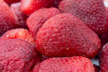 A closeup of frozen strawberries. Strawberries thawed after freezing. The concept of harvesting...