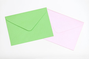 Green and pink envelopes on pastel background.