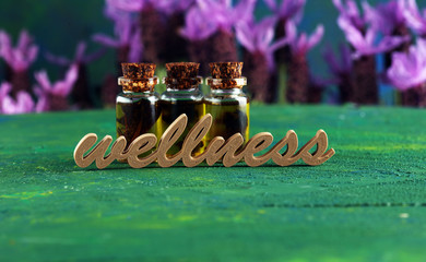 lavender herbal oil and lavender flowers. bottle of lavender massage oil for aromatherapy treatment...