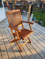 Fototapeta na wymiar wooden deck chair on backyard patio