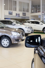 New cars at dealer showroom. Themed blur background with bokeh effect.