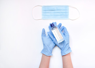 antivirus mask, alco gel and hands with gloves on the table