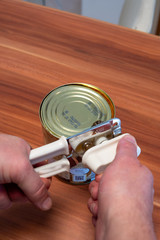 a tin can is opened with the help of a can opener