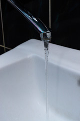 Tap water flows into the sink
