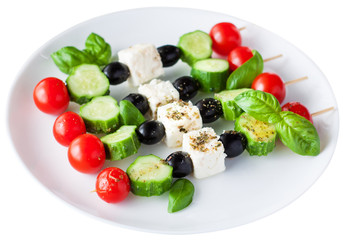 Greek salad skewers, isolated over white background.