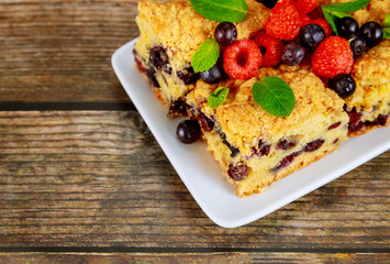 Blueberry pie on wooden background.