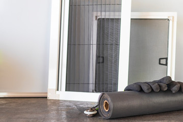 production room. A roll of mosquito net in the foreground. In the background are several frames...