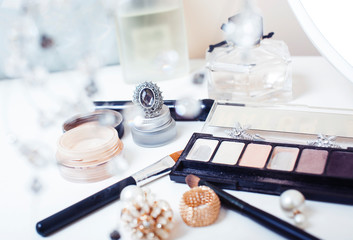 Jewelry table with lot of girl stuff on it, little mess in cosmetic brushes, women interior concept, perfume elegance things, little princess makeup © iordani