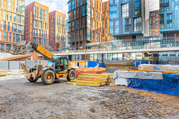escavator on the construction site of a residential complex of houses