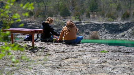 Two young women enjoying a picnic with a view on top of the limestone quarry at France Park near Logansport Indiana