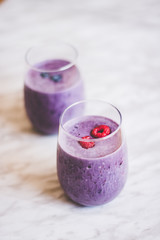smoothie purple berry in glass on white marble