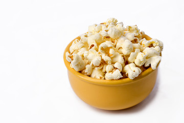 popcorn in the yellow bowl on white background with space for text.typical brazilian june party