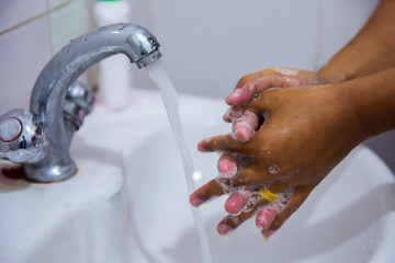 Washing the hands in bathroom to prevent getting sick