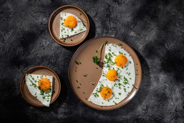 Fried eggs on a ceramic plate with herbs
