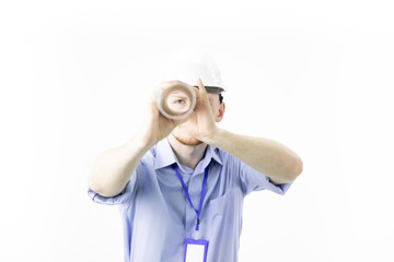 confident and positive young engineer wearing white helmet holds rolled-up drawing like spyglass looks at camera isolated on white background . isolated on white background .
