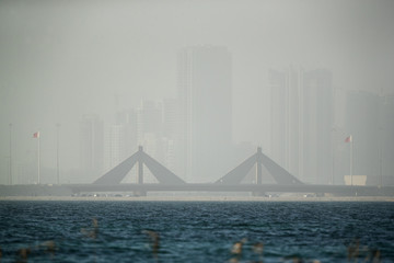 Fototapeta na wymiar Sheikh Salman Causeway bridge and Bahrain skyline during duststorm