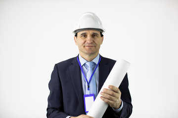 positive and friendly handsome engineer constructor wearing white helmet holds rolled-up drawing looks at camera isolated on white background .