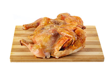 Roasted chicken on the wooden board isolated on white background