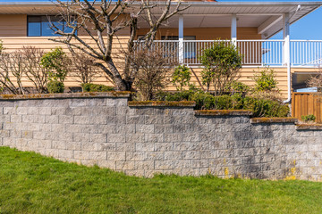 Fence built from trees and stones. Outdoor landscape. Security and privacy concept. Vancouver. Canada.